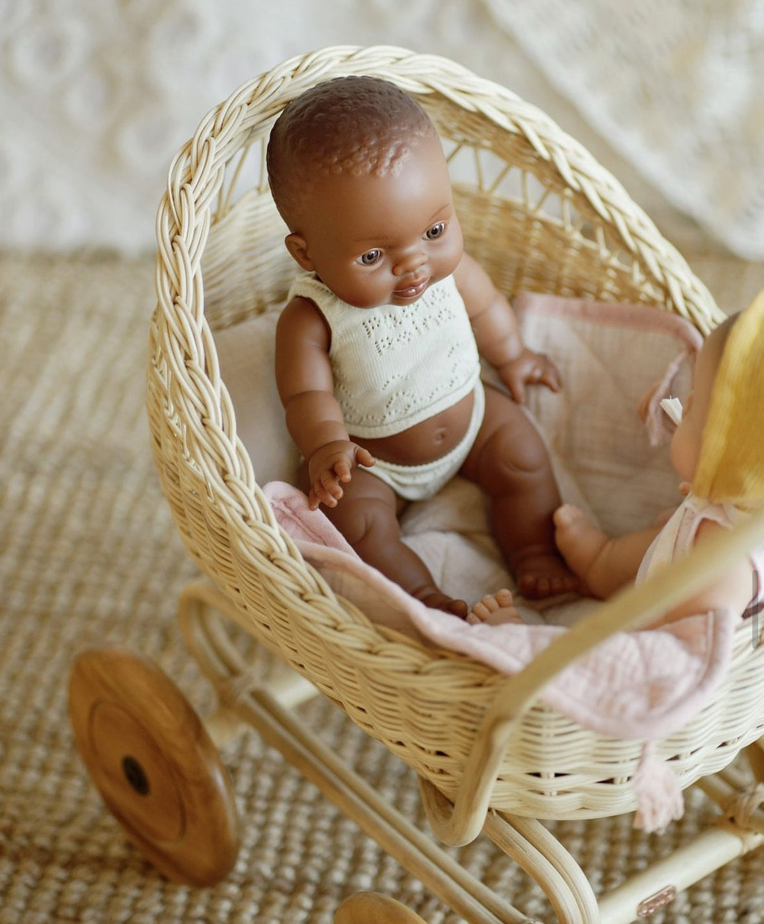 Baby doll with a white outfit on a light gray background